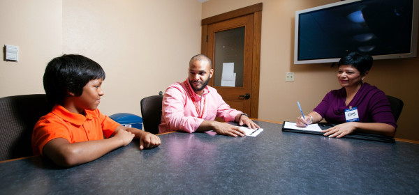 Casa Cps Agents Speaking With Boy in Conference Room