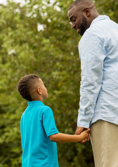 Man Holding Boys Hand
