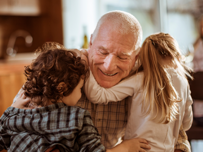 Older Man Hugging Kids